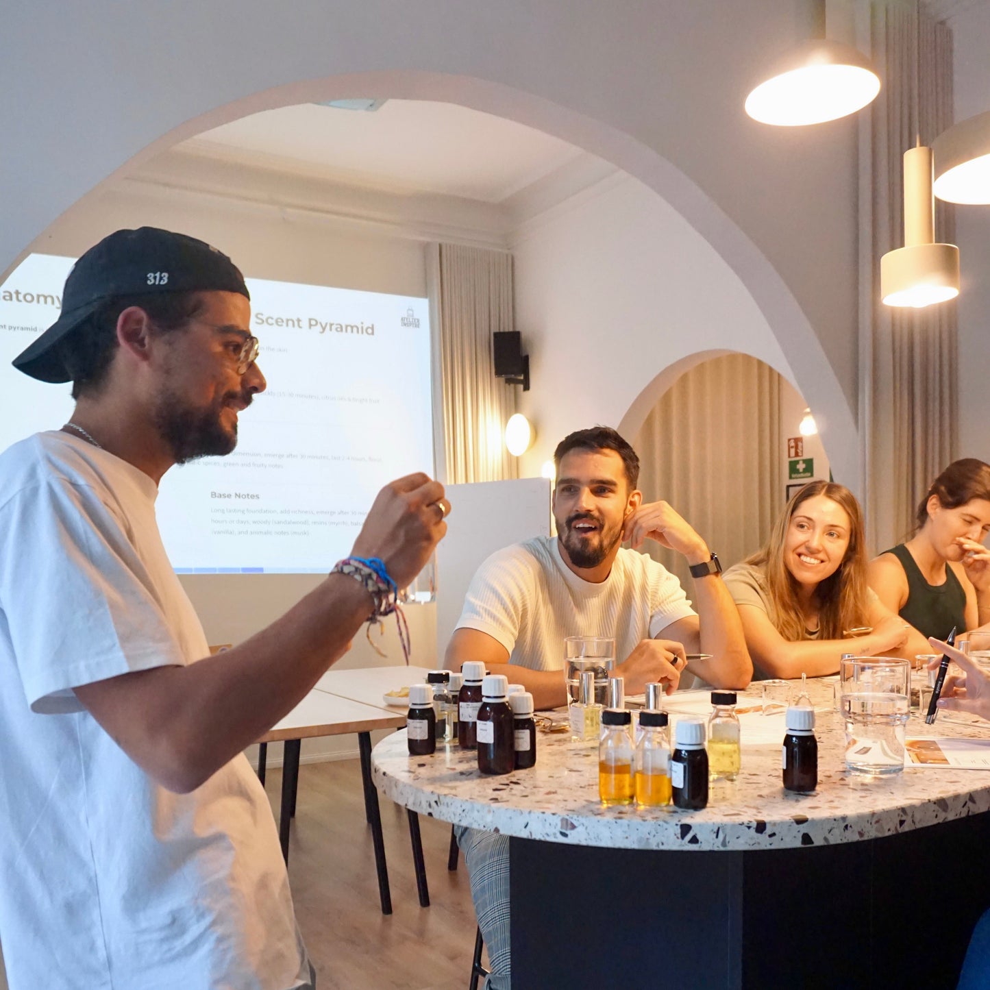 Person giving a presentation to a group of people in a modern office setting.
